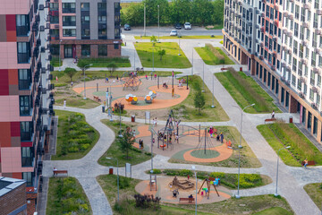 Areal shot of the kids playing on the playground. Urban