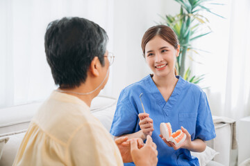 Female Dentist Providing Dental Treatment for Senior Woman at Home. Healthcare and Home Care...