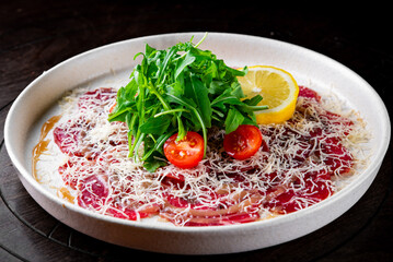 Beef carpaccio with arugula and cheese