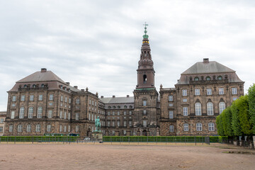 Fototapeta na wymiar Christiansborg Palace or Slot on the islet of Slotsholmen in Copenhagen, Denmark, is the seat of the Danish Parliament (Folketinget), the Prime Minister Office and the Supreme Court
