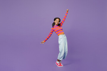 Full body little kid teen girl 15-16 years old wear striped orange sweatshirt stand on toes leaning...