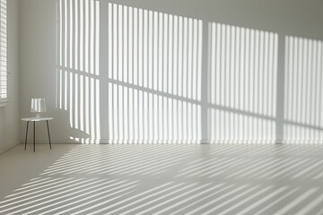 A white room with light from vertical windows hitting the walls.