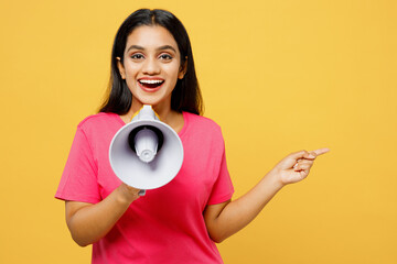 Young surprised Indian woman wearing pink t-shirt casual clothes hold in hand megaphone scream...