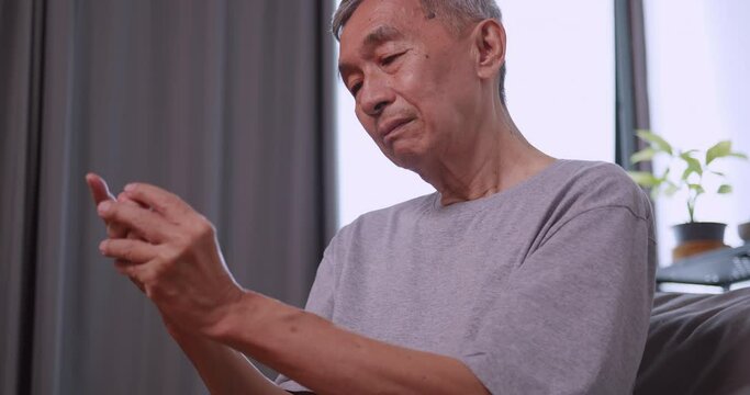 An elderly man's hand is trembling because of Parkinson's disease.