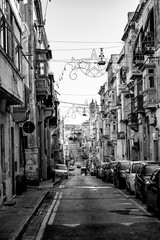 Naklejka premium Small, narrow, mediterranean old town alley. Clotheslines and power cables are stretched from house to house. 