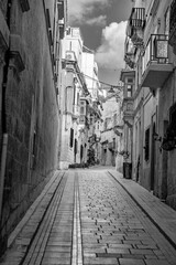Naklejka premium Small, narrow, mediterranean old town alley. Clotheslines and power cables are stretched from house to house. 