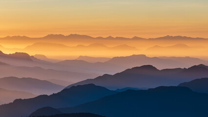 Fototapeta na wymiar Mesmerizing sunrise over majestic mountains, misty valleys & soaring eagles. Nature's grandeur is captured.