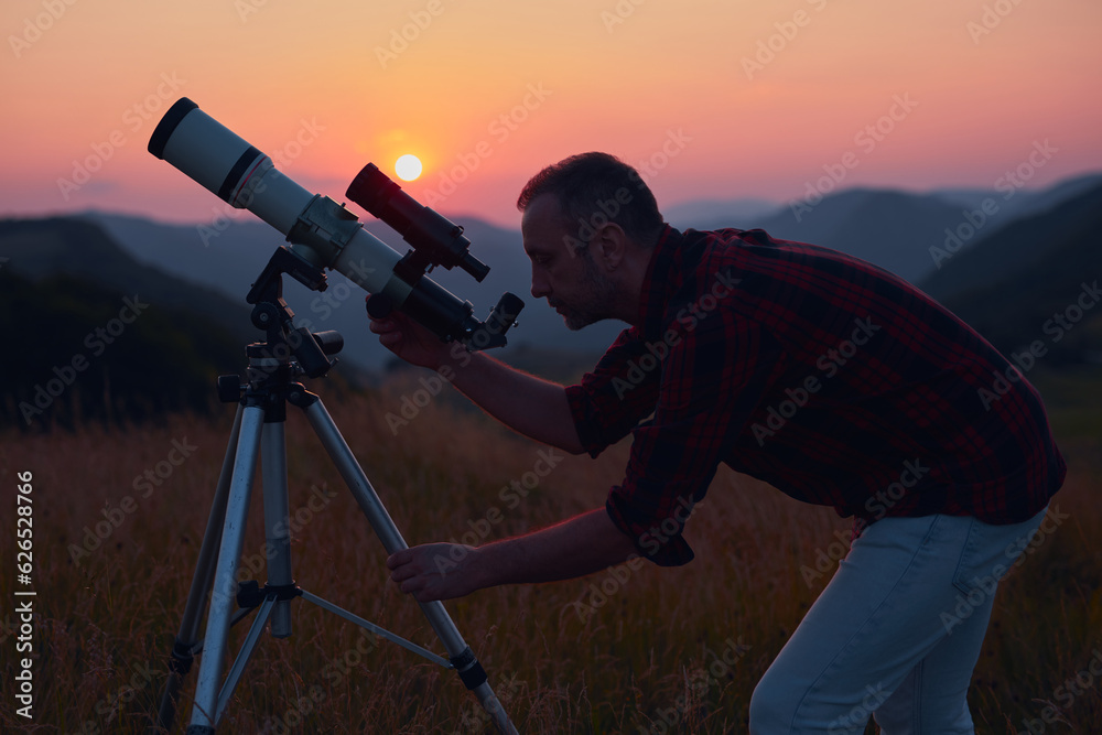 Canvas Prints astronomer looking at the skies with a telescope.
