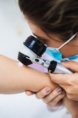 Close up shot of modern dermatology skin check up with digital deramatoscope. Dermoscopy microscope...