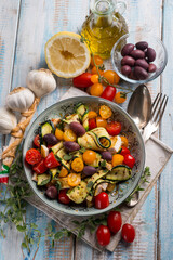 chicken salad with zucchinis cherry tomatoes black olives and lemon