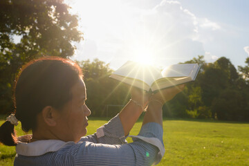 Praise the lord-Woman worshipping god at sunset.