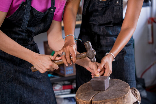 Teacher jeweler and student make jewelry in workshop