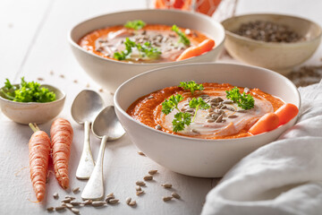 Tasty carrot soup with seeds and cream.