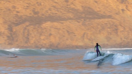 Anonymous Surfers Surfing Small Waves on Atlantic Ocean in Morocco