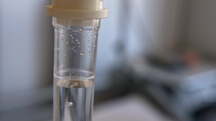 Fluid Drug Dripping from Intravenous Therapy Drip-Bag in Hospital Room