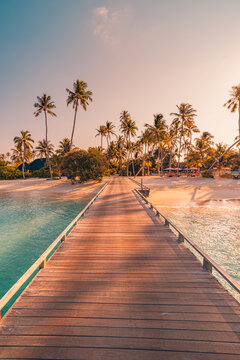 Amazing sunset panorama at Maldives. Luxury resort villas seascape with soft led lights under colorful sky. Beautiful twilight sky and colorful clouds. Beautiful beach background for vacation holiday