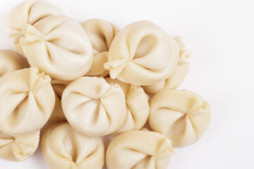 Fototapeta na wymiar Dumplings on white background closeup. Uncooked dumplings. Top view.