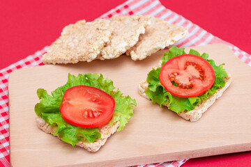 Rice Cake Sandwiches with Tomato and Lettuce on Wooden Cutting Board. Easy Breakfast. Diet Food....