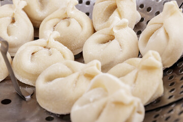Homemade dumplings in the steamer basket prepared to be cooked. Dumplings closeup.