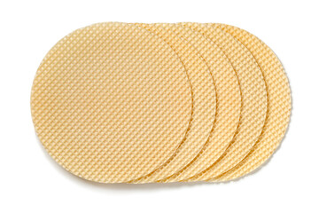 Row of fresh round Polish waffle tortowe isolated on white background close up