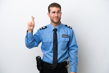 Young police caucasian man isolated on white background with fingers crossing and wishing the best