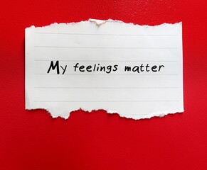Torn note on orange background with handwritten text My Feelings Matter - concept of self validation - affirming self talk to say to yourself