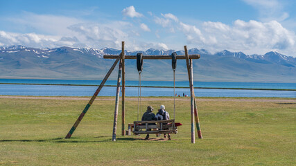 People on the swings on Son kol lake Kyrgyzstan