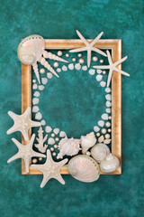 Seashell and pearl abstract border with white shells on mottled turquoise background with gold...