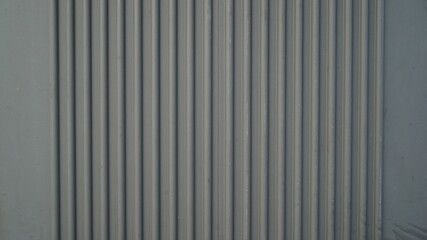 Extruded vertically striped metal wall surface
