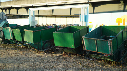 Green carts for garbage collection lined up side by side