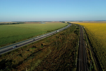 Aerial view at sunrise of A2 Highway motorway road and national railroad between Bucharest and Constanta cities. Amazing beautiful romanian road and railroad.