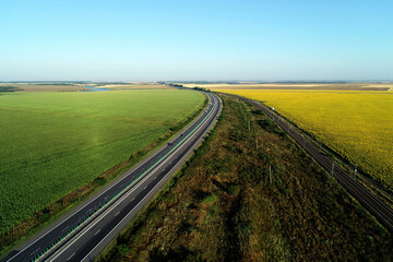 Aerial view at sunrise of A2 Highway motorway road and national railroad between Bucharest and Constanta cities. Amazing beautiful romanian road and railroad.
