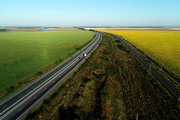 Aerial view at sunrise of A2 Highway motorway road and national railroad between Bucharest and Constanta cities. Amazing beautiful romanian road and railroad.