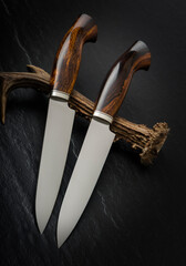 Hunting knife handmade on a black background.

