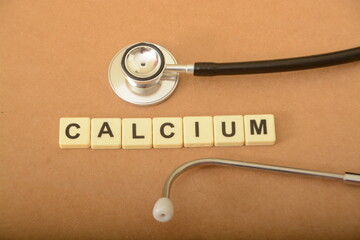 Stethoscope and alphabet letters with text CALCIUM.