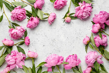 Frame made of pink peony flowers on light background