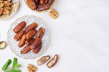 Bowls with dried dates on light background