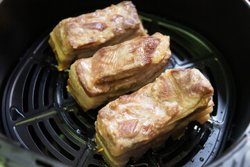 Crispy roast pork belly with air fryer. Place the pork belly in the air fryer and cook for 30 minutes. This will help to dry out the skin and create a more crispy skin. 