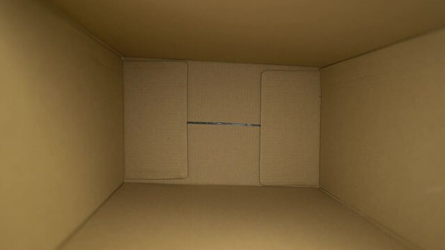 Man hand takes smartphone with chromakey in box small delivery packages. green screen phone. m-commerce concept. shopping from phone. package delivery. High quality 4k footage