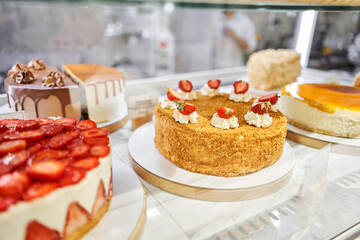 fresh pastries with berries. A variety of fresh pastries in the bakery window. Strawberry cake. The interior of an Italian restaurant.