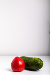 tomato and cucumber lie on a white background