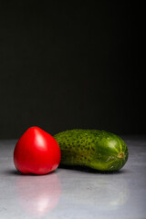 cucumber and tomato on a black background, isolated