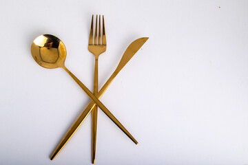 golden fork, knife and spoon