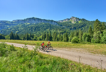 two senior girl friends having fun during a cycling tour in the Bregenz Forest near Sibratsgfäll, Vorarlberg, Austria