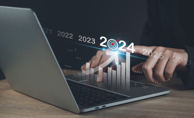 Target and goal of 2024 year business new year concept.  Businessman touching future showing...