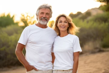Fotobehang Old mature couple with matching Mockup White t-shirt Mockup , happy lovely man and woman © Keitma