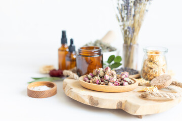Botanical blends, herbs, essencial oils for naturopathy. Natural remedy, herbal medicine, blends for bath and tea on white wooden table background