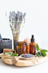 Botanical blends, herbs, essencial oils for naturopathy. Natural remedy, herbal medicine, blends for bath and tea on white wooden table background