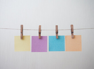 colored paper for notes hanging on a clipboard