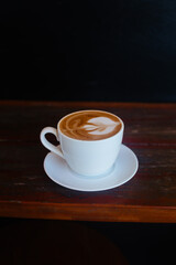 Cappuccino slatte art in a white mug on the table